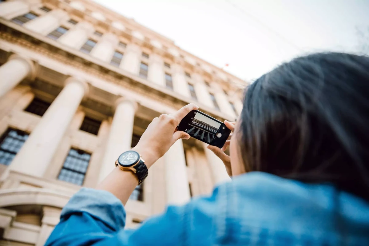 Tourist taking photo of a building